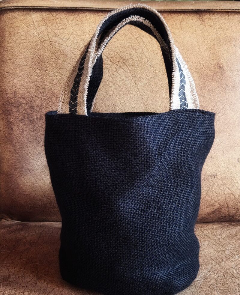 Chicca — small dark textile bucket bag with cream stripe handles